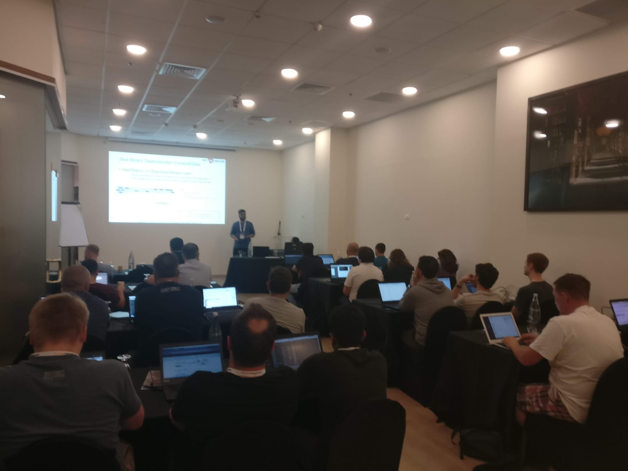 A blurry photo of Dhruv Shah delivering some hands-on hacking training at Global AppSec Tel Aviv 2019